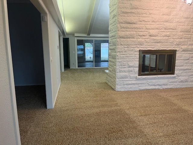 hallway with carpet and beam ceiling