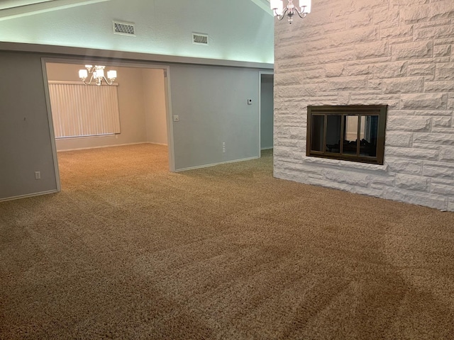 unfurnished living room with an inviting chandelier, a stone fireplace, high vaulted ceiling, and carpet