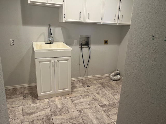 washroom featuring cabinets, washer hookup, hookup for an electric dryer, and sink