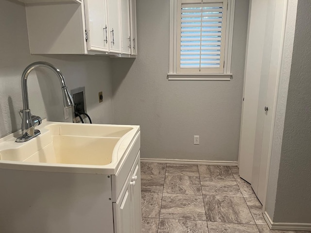 clothes washing area with cabinets, sink, hookup for a washing machine, and electric dryer hookup