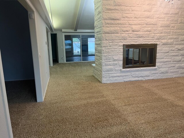 hall featuring beamed ceiling and carpet flooring