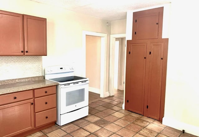 kitchen featuring backsplash, a textured ceiling, and white electric range oven