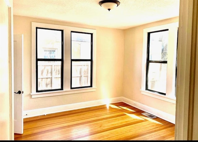 unfurnished room featuring hardwood / wood-style floors