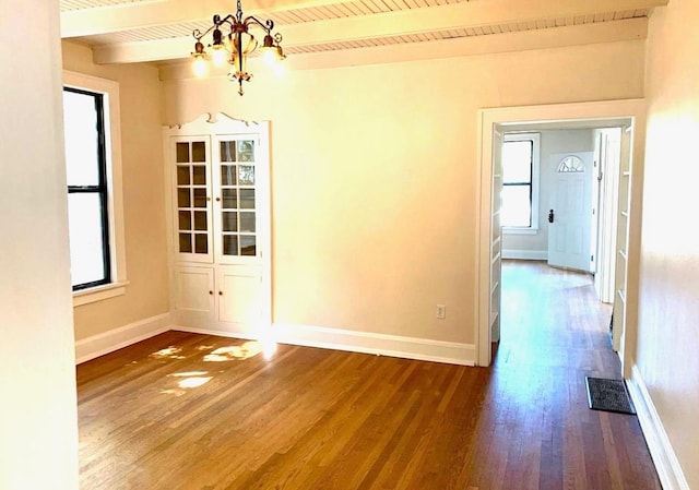 spare room with hardwood / wood-style flooring, a healthy amount of sunlight, wood ceiling, and beamed ceiling