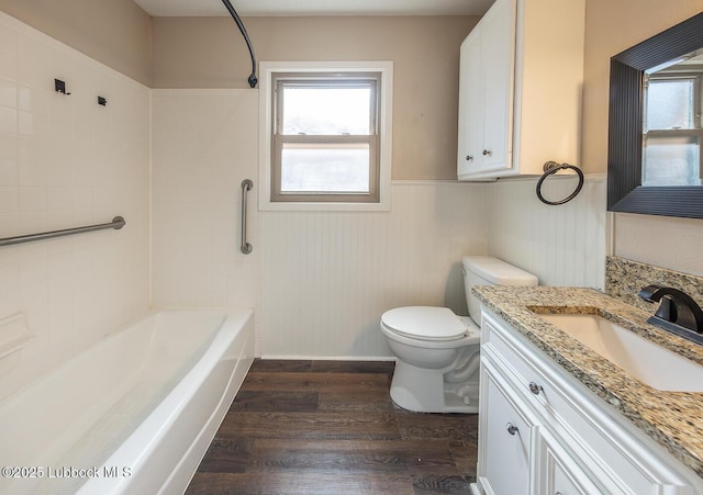 3423 60th St, Lubbock, TX 79413 - bathroom with wood finished floors, wainscoting, vanity, and shower / washtub combination