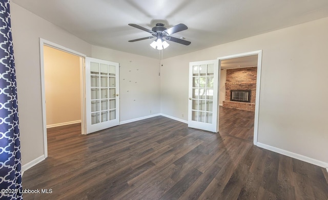 3423 60th St, Lubbock, TX 79413 - spare room featuring french doors, wood finished floors, ceiling fan, and a fireplace