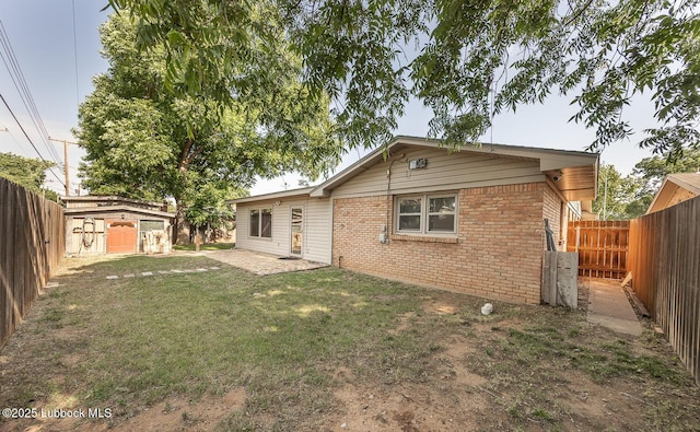 3423 60th St, Lubbock, TX 79413 - rear view of property featuring brick siding, a fenced backyard, and a shed