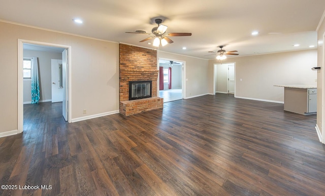 3423 60th St, Lubbock, TX 79413 - unfurnished living room featuring ceiling fan, ornamental molding, recessed lighting, a fireplace, and dark wood-style floors