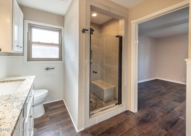 3423 60th St, Lubbock, TX 79413 - bathroom with vanity, a stall shower, and wood finished floors