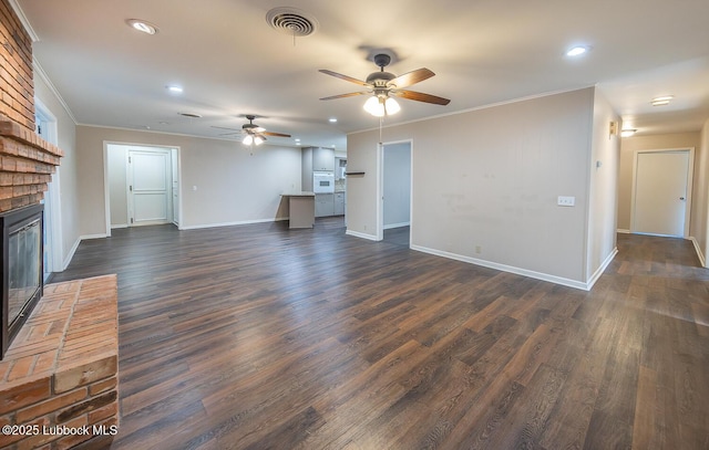 3423 60th St, Lubbock, TX 79413 - unfurnished living room featuring a fireplace, ceiling fan, crown molding, recessed lighting, and dark wood-style flooring