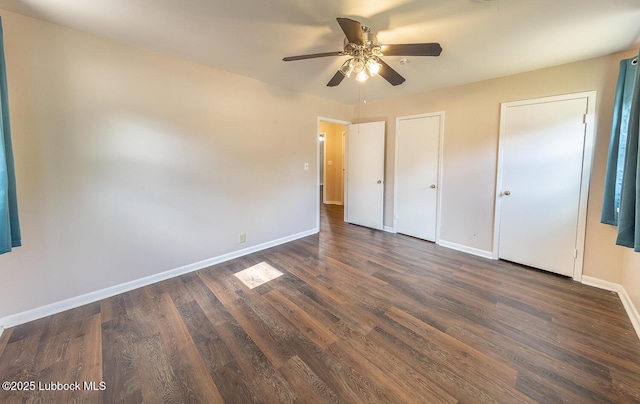 3423 60th St, Lubbock, TX 79413 - unfurnished bedroom with dark wood-type flooring, multiple closets, and ceiling fan