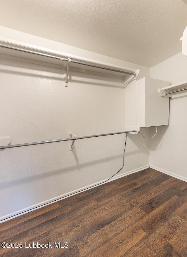 3423 60th St, Lubbock, TX 79413 - walk in closet with dark wood-style flooring