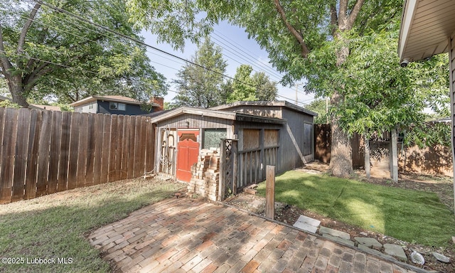 3423 60th St, Lubbock, TX 79413 - fenced backyard featuring an outbuilding and a patio area