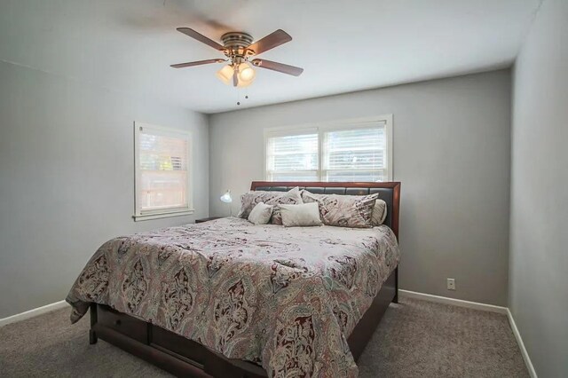 bedroom featuring dark carpet and ceiling fan