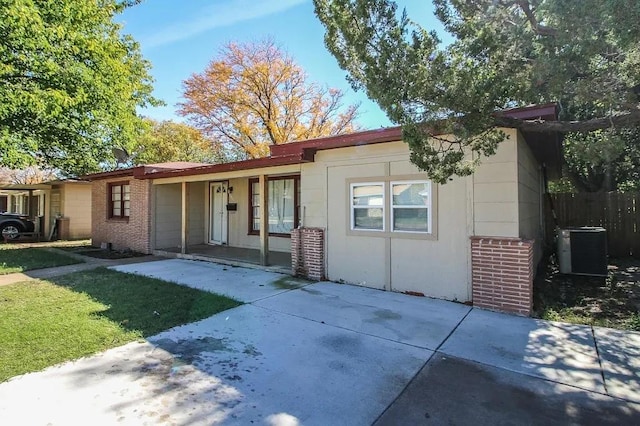 ranch-style home featuring cooling unit