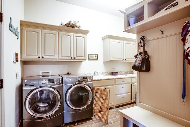 laundry room featuring cabinets, washing machine and clothes dryer, and sink