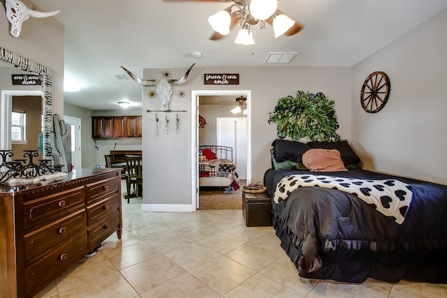 bedroom featuring light tile patterned floors and ceiling fan