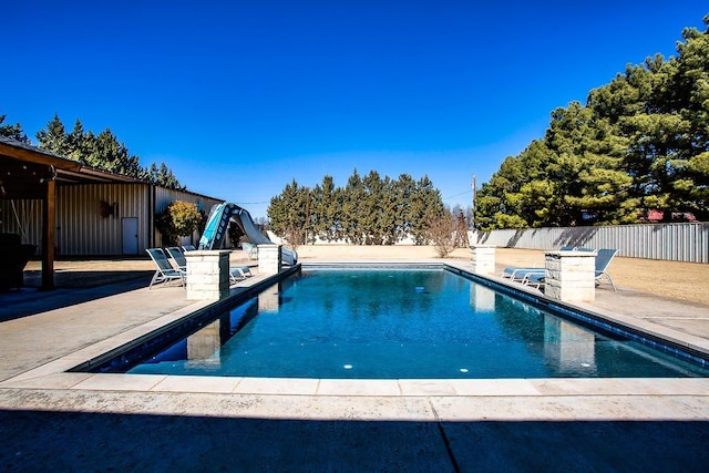 view of pool featuring a patio and a water slide