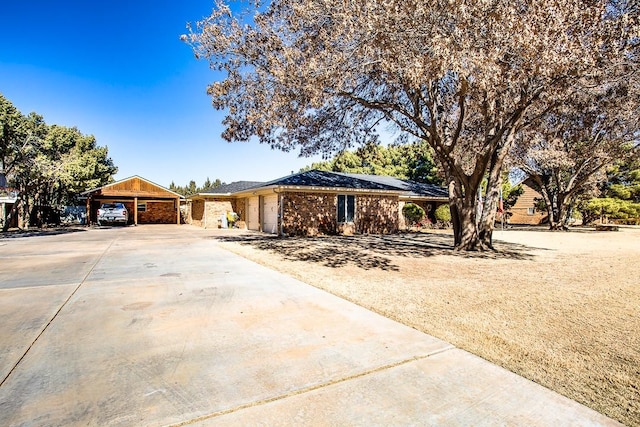 ranch-style house featuring a carport and a garage