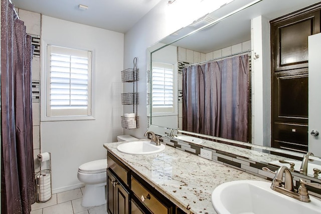 bathroom with vanity, tile patterned flooring, and toilet