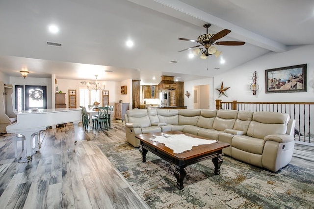 living room with vaulted ceiling with beams, ceiling fan with notable chandelier, and light hardwood / wood-style flooring