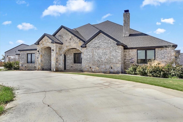 french provincial home featuring a front lawn