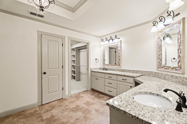 full bathroom featuring double vanity, visible vents, crown molding, and a sink