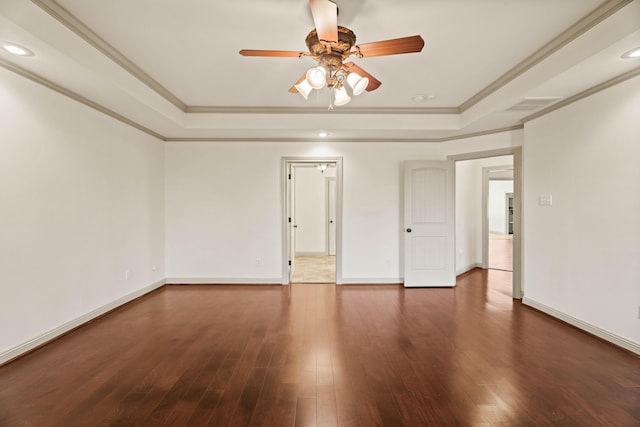 spare room featuring hardwood / wood-style floors, ceiling fan, crown molding, and a tray ceiling