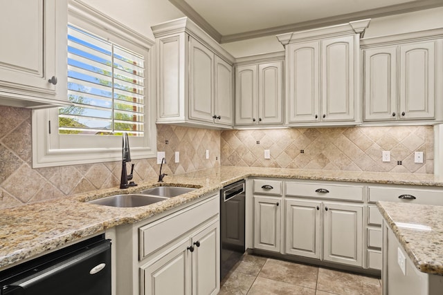 kitchen with a sink, black dishwasher, backsplash, light stone counters, and stainless steel dishwasher