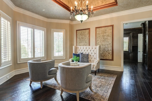 sitting room featuring crown molding, plenty of natural light, and dark hardwood / wood-style floors