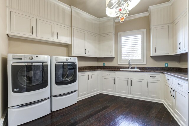 washroom with sink, dark hardwood / wood-style flooring, cabinets, ornamental molding, and independent washer and dryer