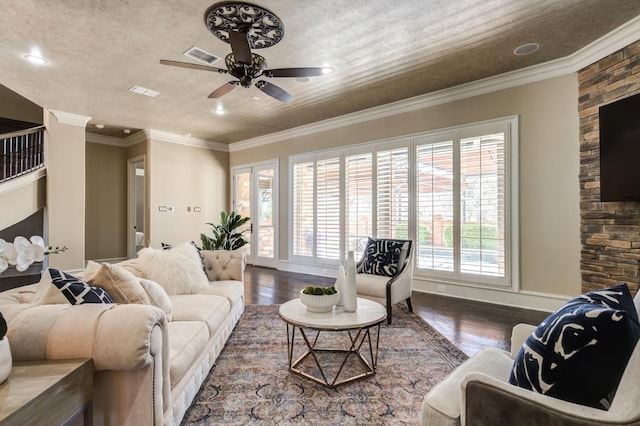 living room with crown molding, wood-type flooring, and ceiling fan