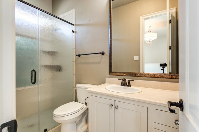 bathroom with vanity, walk in shower, and toilet