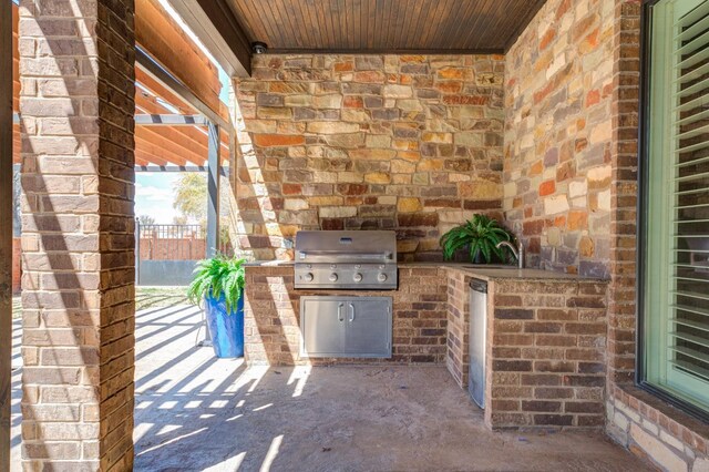 view of patio with area for grilling, grilling area, and sink