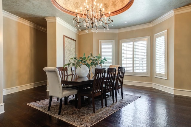 dining space with ornamental molding, dark wood-type flooring, a textured ceiling, and an inviting chandelier