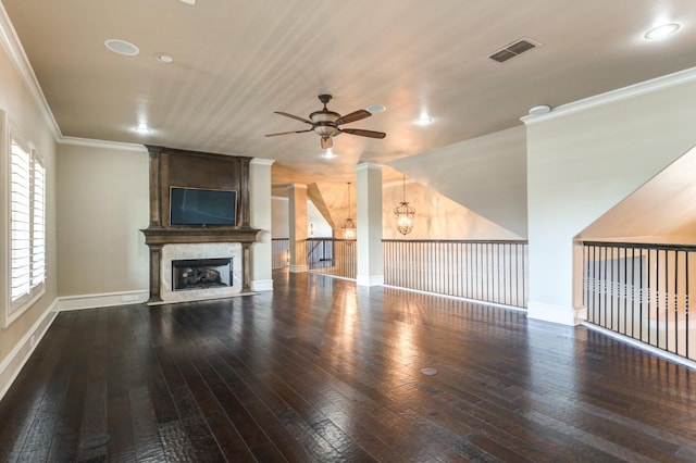 unfurnished living room with a premium fireplace, crown molding, dark hardwood / wood-style floors, and ceiling fan