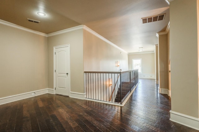 corridor with dark hardwood / wood-style flooring and ornamental molding