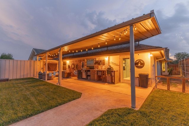 6109 Elkhart Ave, Lubbock, TX 79424 - patio terrace at dusk with a fenced backyard, a patio, and an outdoor hangout area