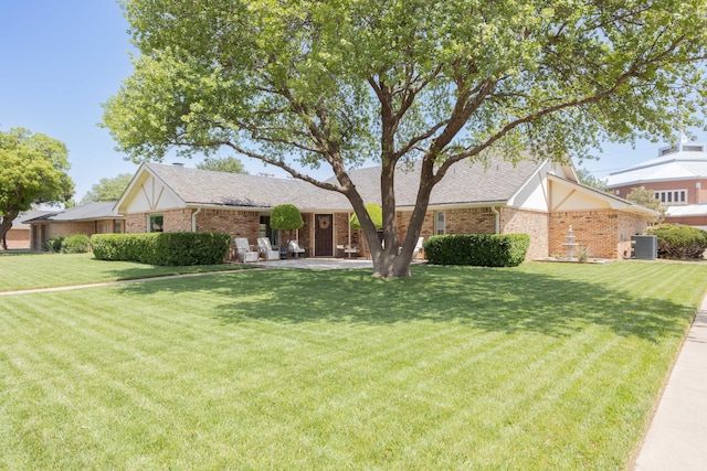 6109 Elkhart Ave, Lubbock, TX 79424 - view of front facade featuring a front lawn, brick siding, and a shingled roof