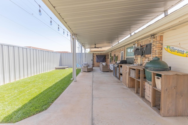 6109 Elkhart Ave, Lubbock, TX 79424 - fenced backyard with ceiling fan, an outdoor kitchen, a patio area, and an outdoor living space