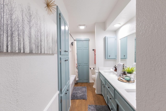 6109 Elkhart Ave, Lubbock, TX 79424 - bathroom with double vanity, wood finished floors, and bathing tub / shower combination