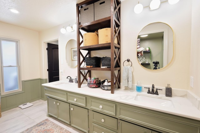 6109 Elkhart Ave, Lubbock, TX 79424 - full bathroom with double vanity, wainscoting, tile patterned floors, and a textured ceiling