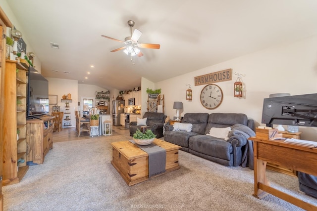 carpeted living room with vaulted ceiling and ceiling fan