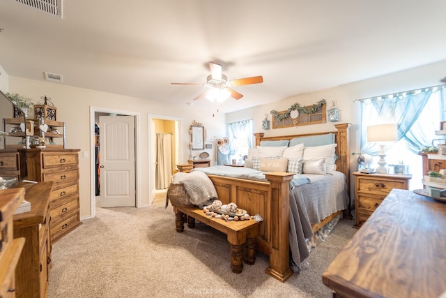 bedroom featuring light carpet, ceiling fan, and a closet