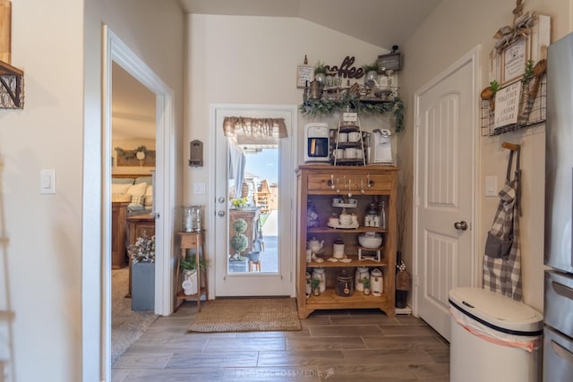 doorway to outside with lofted ceiling