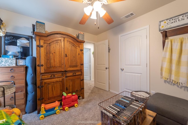 rec room featuring light carpet and ceiling fan