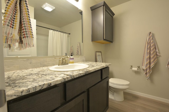 bathroom featuring a shower with curtain, vanity, toilet, and hardwood / wood-style floors