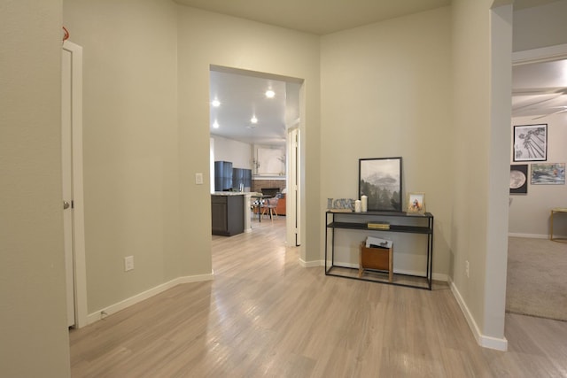 hallway with light hardwood / wood-style flooring