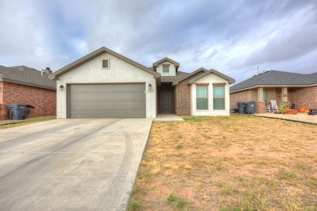 view of front of property with a garage and a front lawn