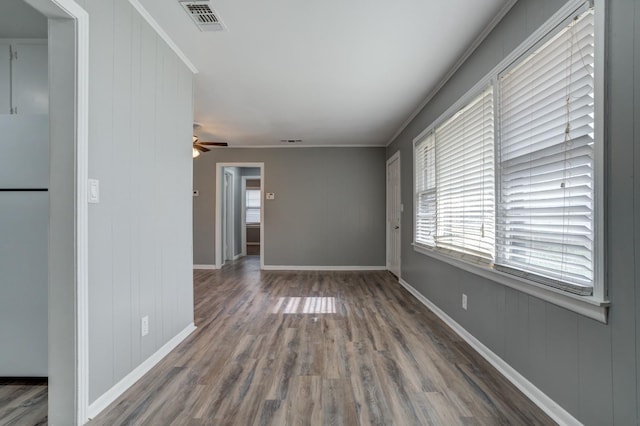 unfurnished room featuring hardwood / wood-style flooring, ornamental molding, and ceiling fan